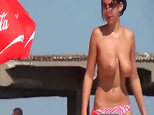 Young lady lying on the beach tried to become a tan and massage